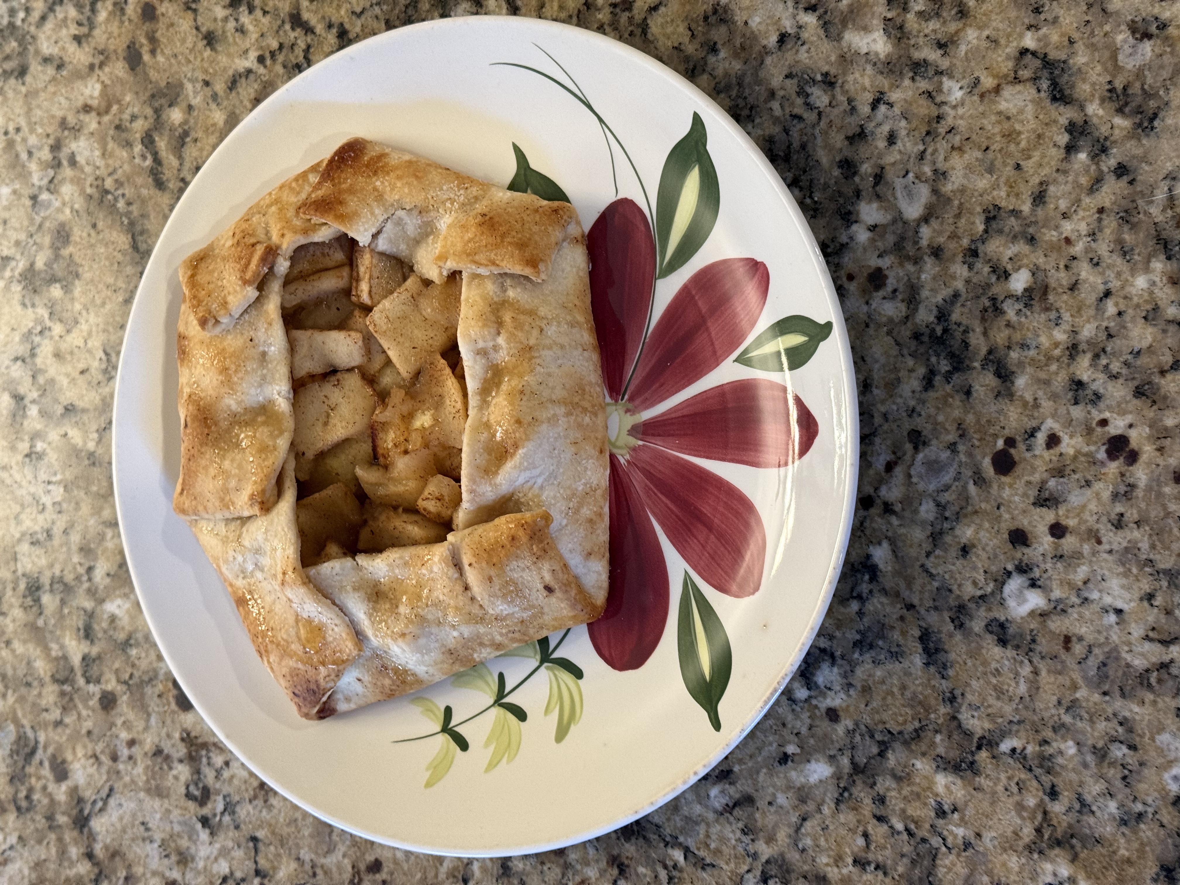 Rustic apple galette on a floral plate
