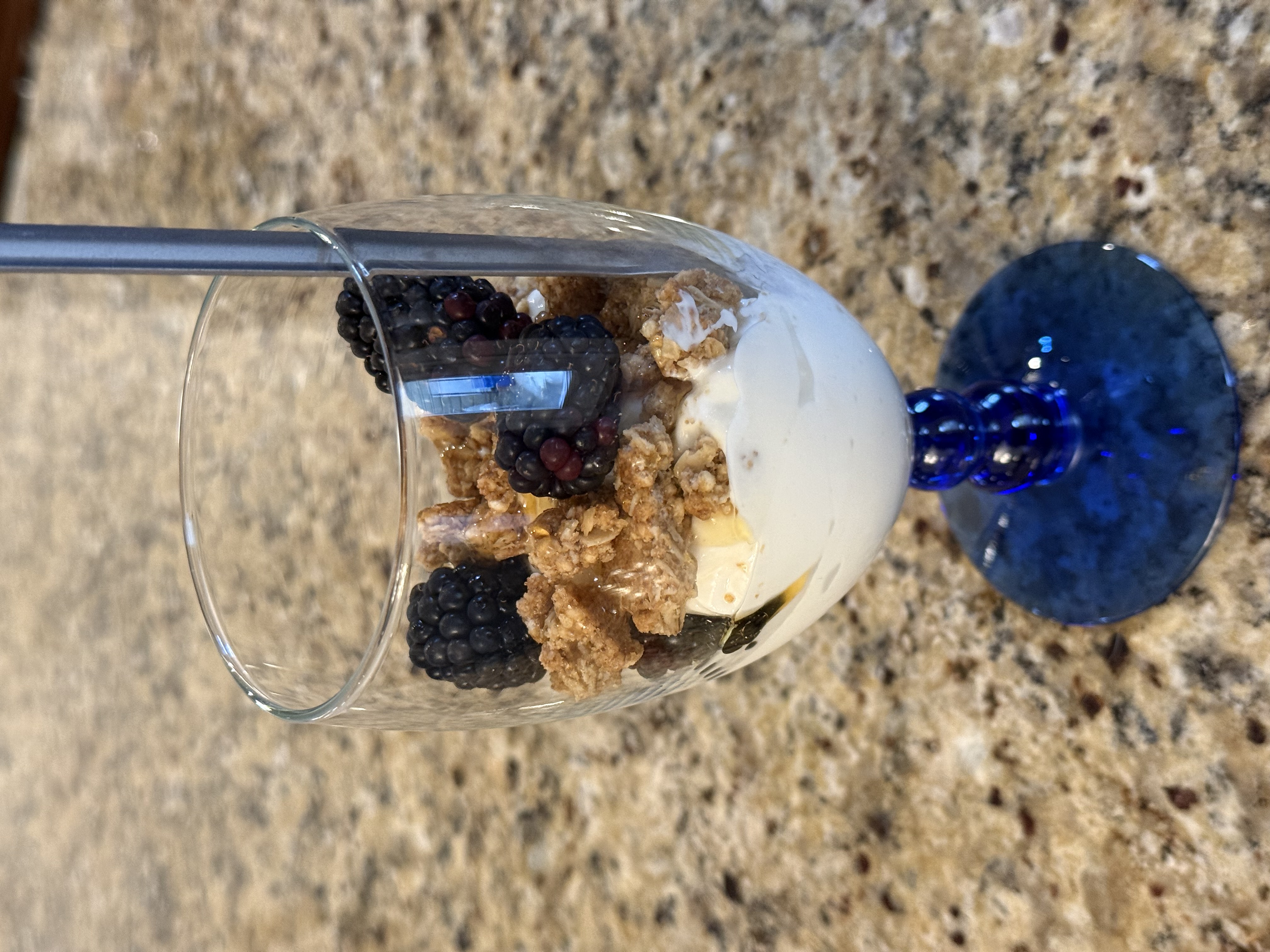Blackberry parfait in a glass with granola and fresh berries