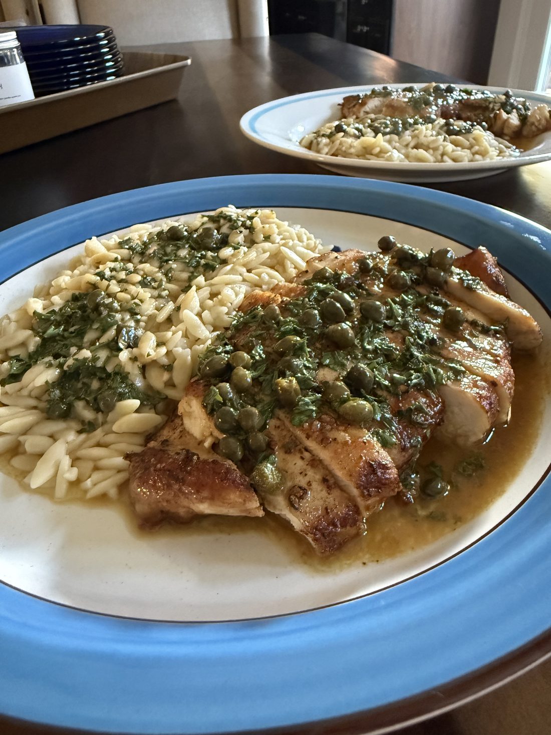 Chicken piccata with lemon butter caper sauce over orzo