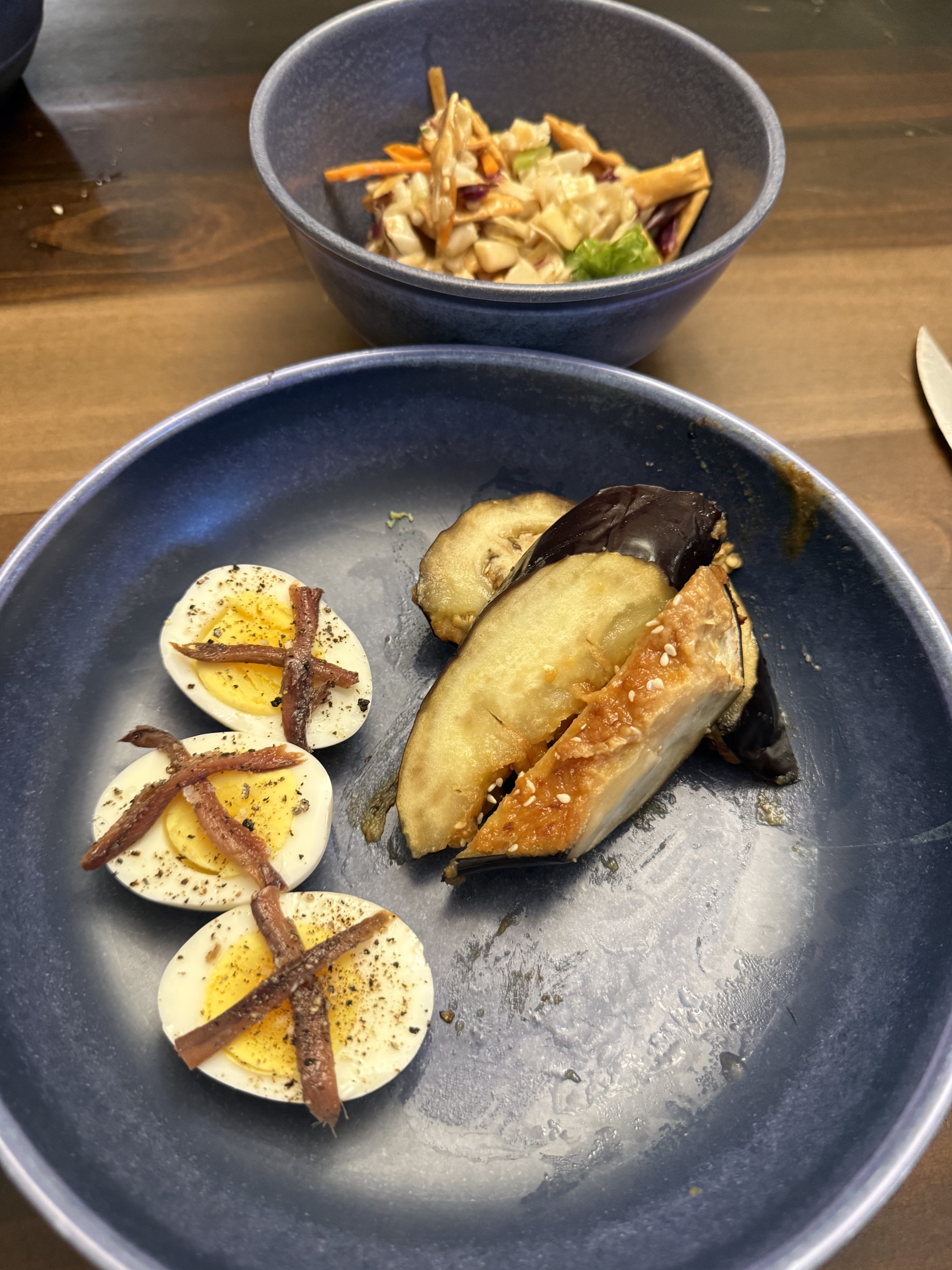 Broiled eggplant halves with caramelized miso glaze, scored flesh, sesame and scallion