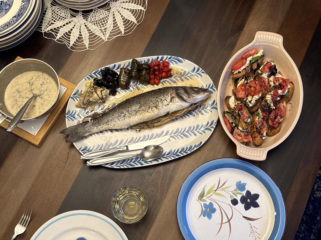 A whole fish oven-baked with the cavity filled with Mediterranean herbs and coins of lemon