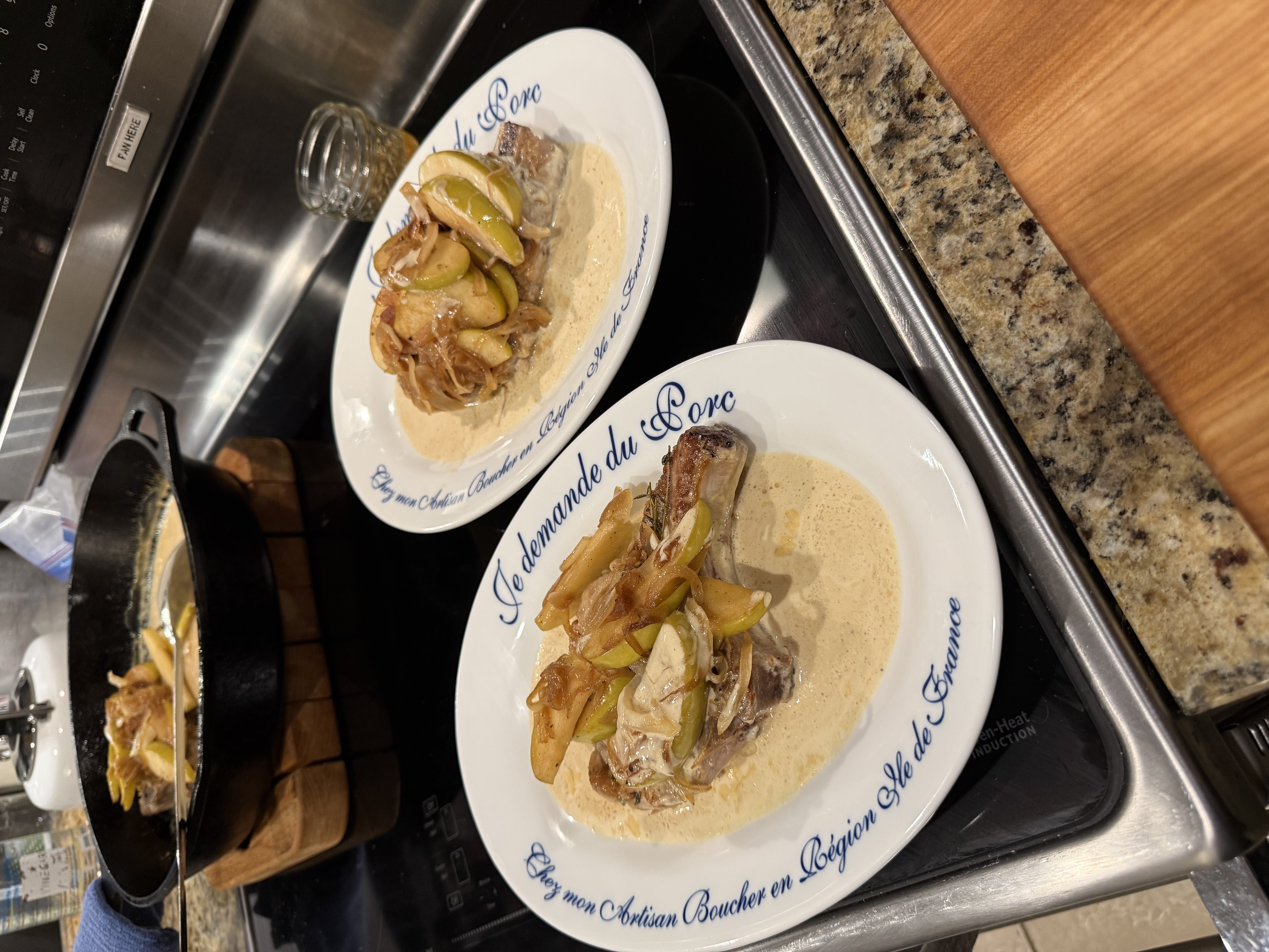 Seared pork chops with caramelized apples and onions in a cream-mustard pan sauce